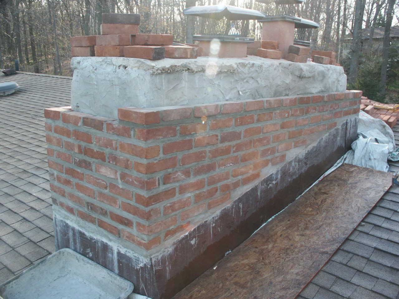 After: the chimney rebuilt in new brick with a clean crown and cap
